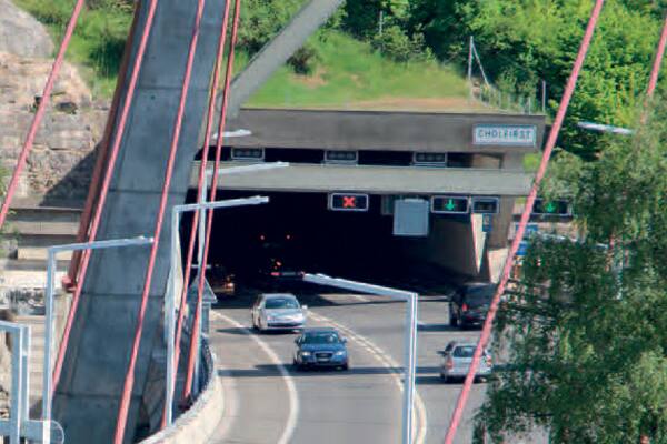 A fleet of cars passing through a tunnel