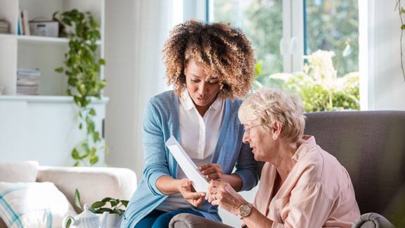 A caregiver taking care of an elderly lady