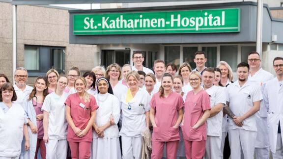 Group of nurses and doctors smiling for a picture