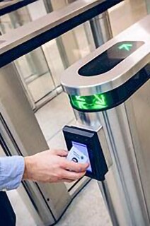 A man scanning his ID card in an access control door