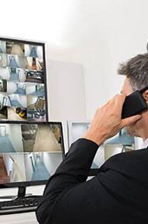 Security officer monitoring cctv footage