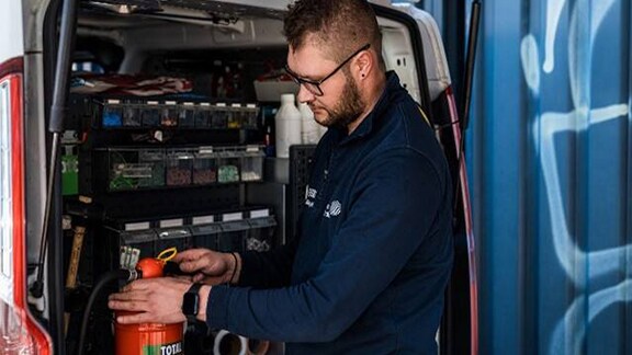 Firefighter inspecting a fire extinguisher