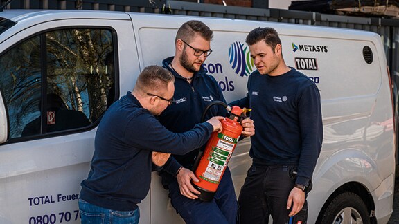 Fireman checking extinguisher