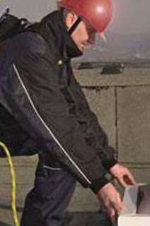 Firefighter inspecting a heat exhaust ventilation system