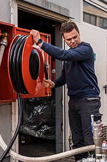 Firefighter unwinding a water hose