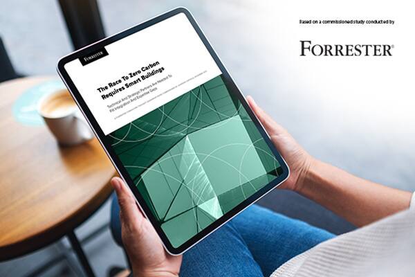 A handheld tablet displaying an article by Forrester with the Forrester logo superimposed in the right upper corner of the image