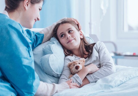 Nurse taking care of girl in hospital